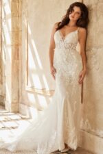Model in Jovani JB37532 ivory gown with lace and deep V-neckline from the front.