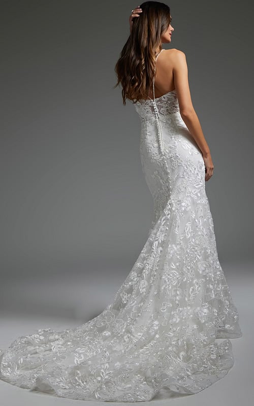 Model wearing Jovani JB37538 white gown, back view, showing off the seamless finish and elegant button detailing.