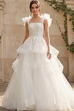 Elegant ball gown wedding dress with tiered tulle skirt and ruffled shoulder straps