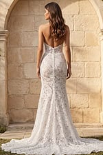 Back view of a strapless lace mermaid gown with low back, button closure, and scalloped lace train.