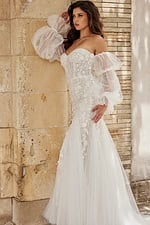 Model in Jovani JB38491 white dress showing detail of sheer voluminous sleeves.