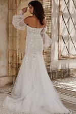 Model showing the back of Jovani JB38491 in white, with lace detail.