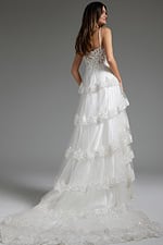 Model wearing JB38641 white dress, back view showcasing lace overlay and delicate straps.