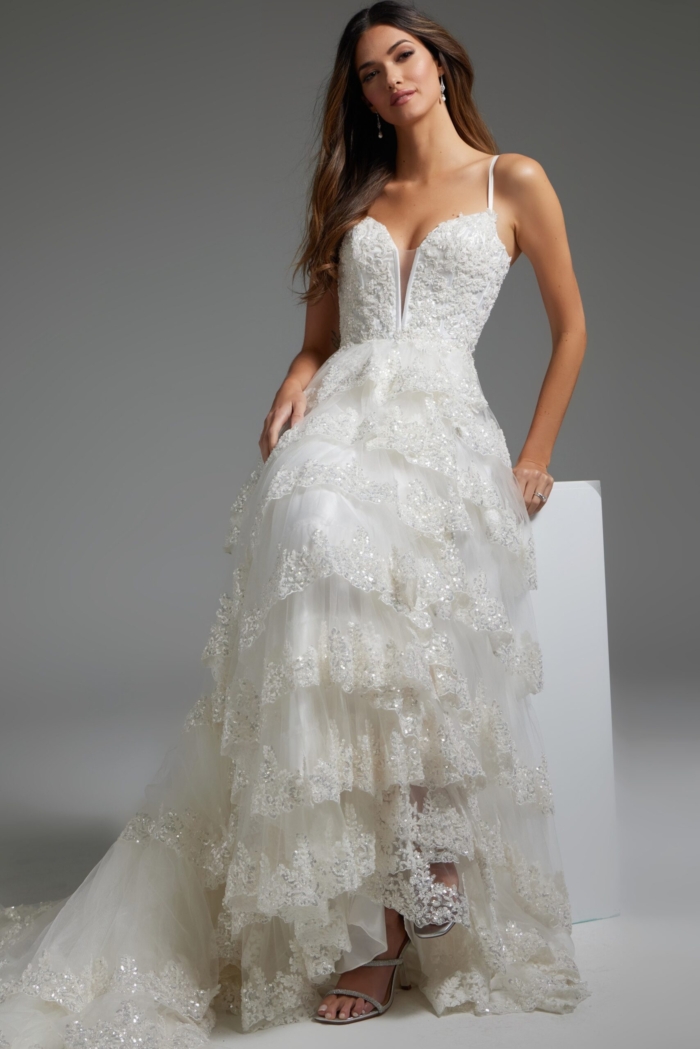 Model wearing JB38641 white dress, front view with cascading layers and lace embellishments.