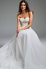 Model sitting in Jovani JB39160 white dress, featuring a sweetheart neckline and voluminous skirt.