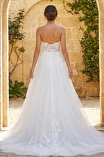 Strapless floral lace wedding gown with sheer bodice and flowing tulle skirt