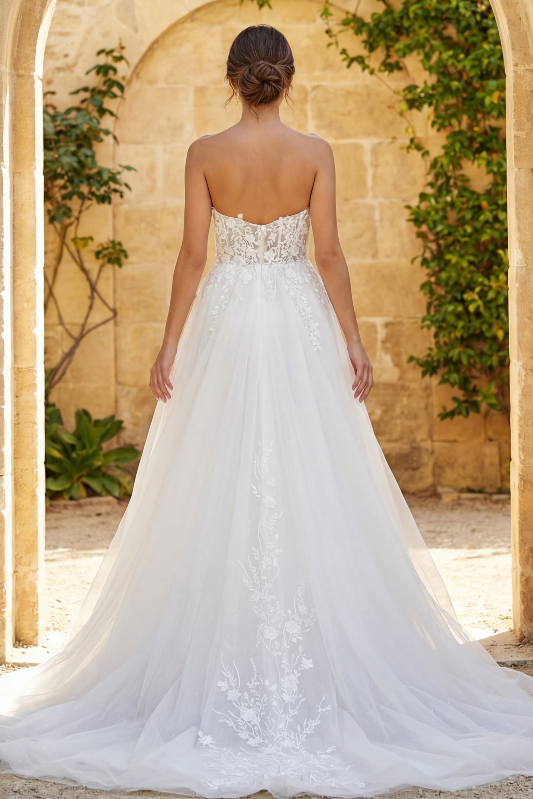 Strapless floral lace wedding gown with sheer bodice and flowing tulle skirt