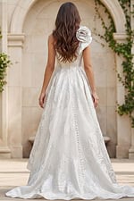 back view of one shoulder wedding gown with button details and full structured skirt