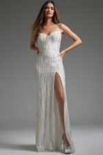 Model wearing Jovani JB39260 fitted white gown showing intricate beadwork.
