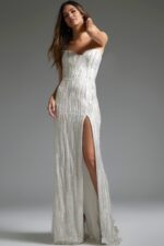 Model in Jovani JB39260 white dress featuring high slit and beadwork.
