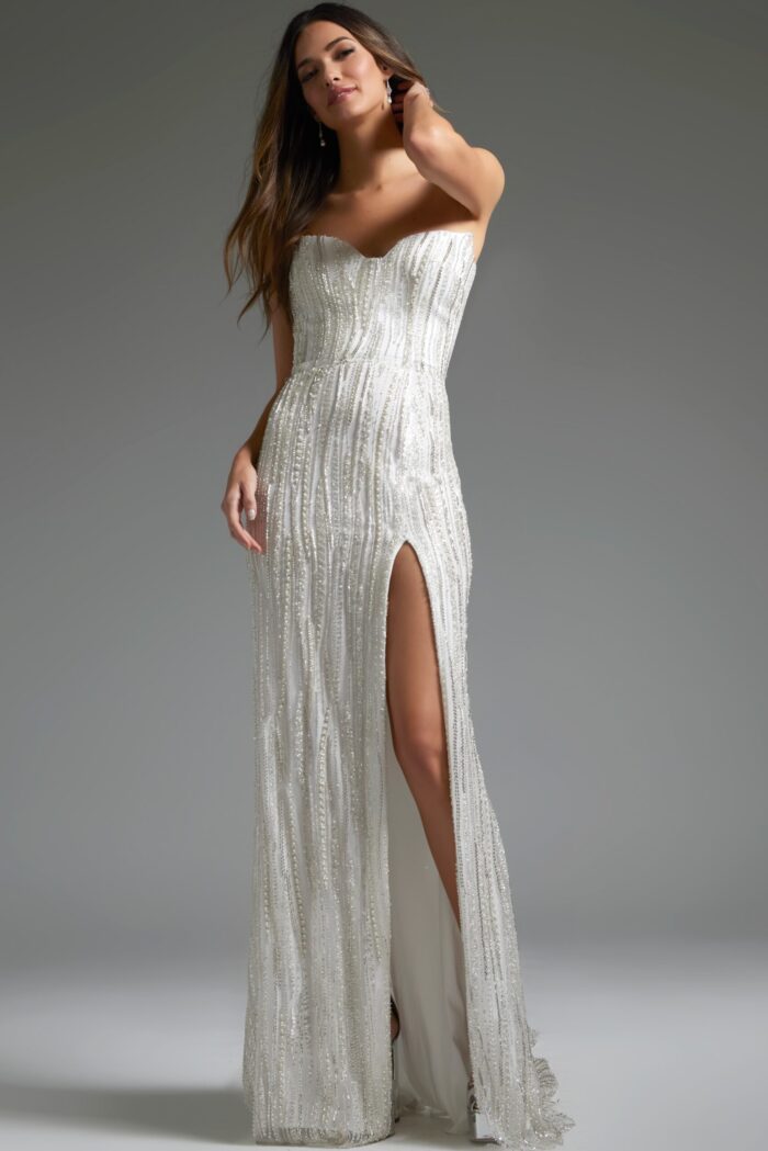 Model in Jovani JB39260 white dress featuring high slit and beadwork.