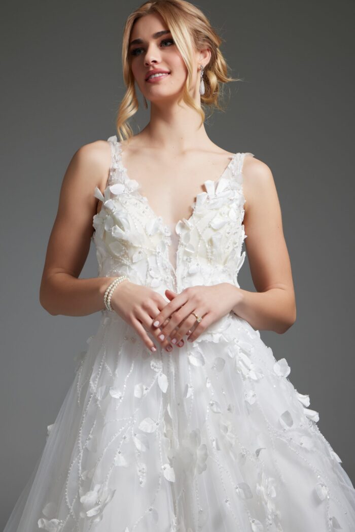 Model wearing Jovani JB40511 ivory gown, close-up front view, with deep V-neckline.