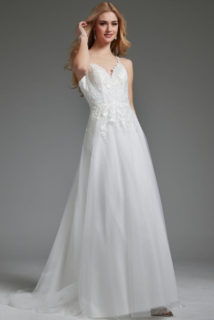 Model wearing Jovani jb40513 ivory gown with V-neckline and floral appliqués.