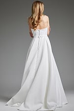 Model wearing Jovani JB40599 white gown, showcasing elegant back design.
