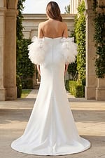 Back view of fitted gown with dramatic tulle sleeves and button train