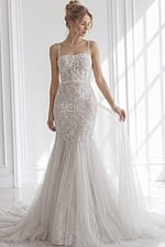 Open-back lace mermaid wedding gown with slim spaghetti straps and flared tulle train