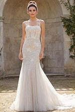 Mermaid bridal gown with floral beading, sheer bodice, and flowing tulle train