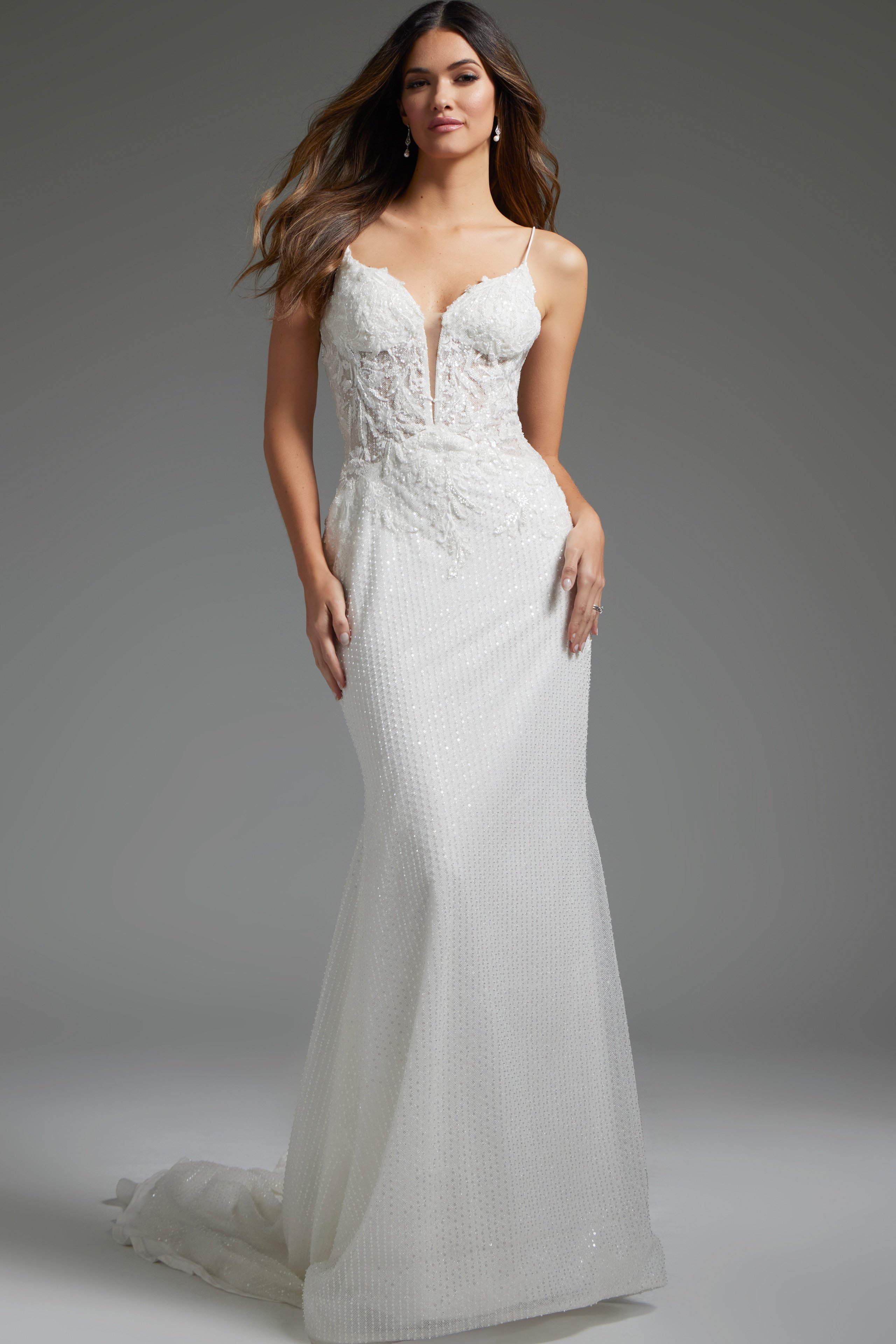 JB40639-IVORY-202.jpg Model wearing Jovani JB40639, an elegant ivory gown with a plunging neckline and intricate lace details from the front.