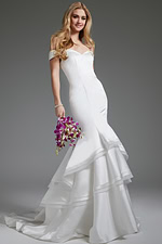 Model wearing Jovani JB40790 white mermaid gown with off-the-shoulder neckline