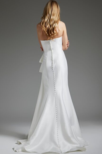 Back view of model in Jovani JB40791 white gown with button detail.
