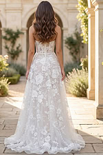 Back view of strapless lace wedding gown with floral embroidery and flowing train
