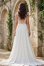 Back view of a flowing A-line bridal gown with lace illusion back, button closure, and soft chapel train