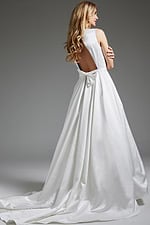 Model displaying JB42319 ivory gown, back view with bow detail and luxurious train