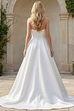 minimalist strapless wedding dress with structured bodice and long flowing train