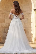 Strapless embroidered wedding dress with flowing tulle skirt and detachable sheer sleeves
