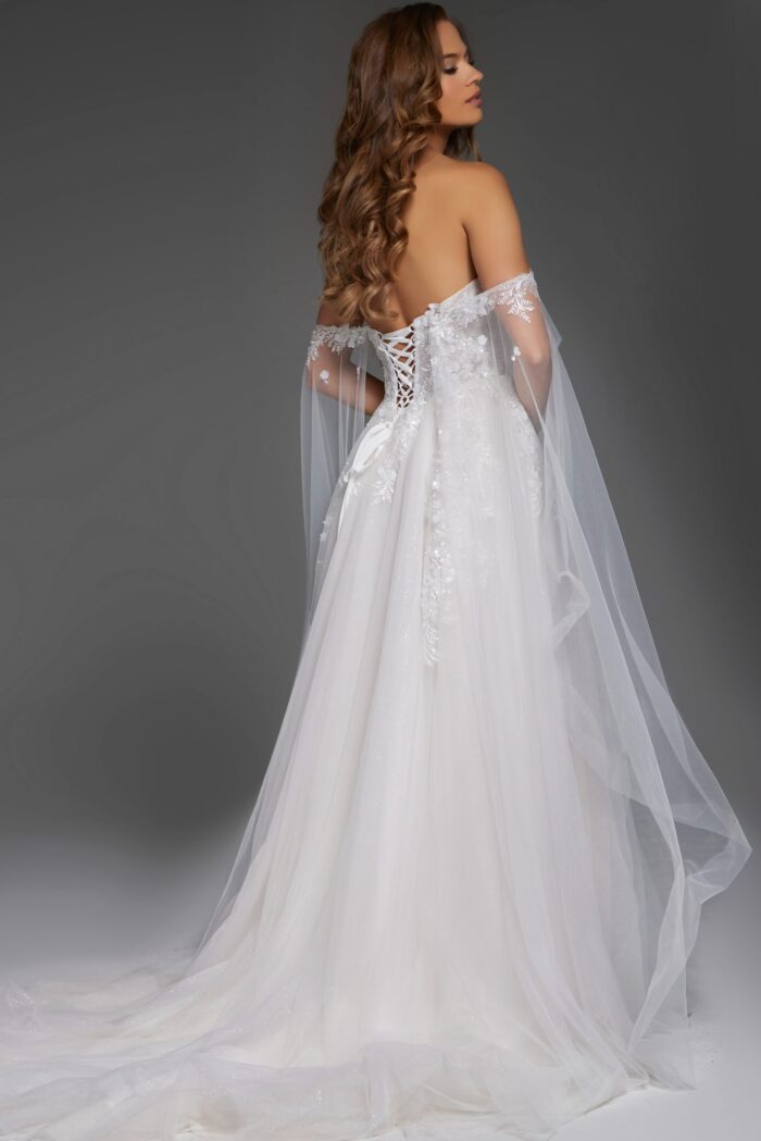 Model in Jovani JB42481 showcasing back of the white gown with sheer sleeves.
