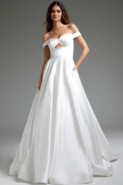 Model wearing Jovani JB42626 off-the-shoulder white dress with cutout at the bodice.