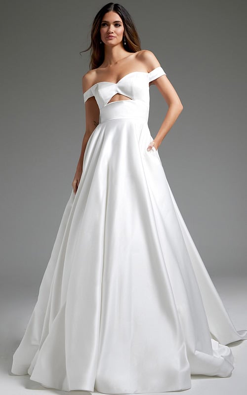 Model wearing Jovani JB42626 off-the-shoulder white dress with cutout at the bodice.