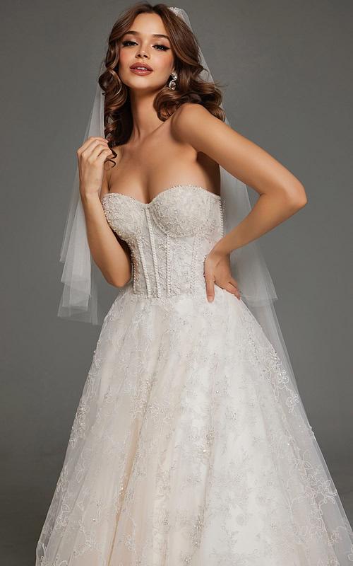 Close-up of model wearing JB42766 white gown, showing intricate embroidery and sweetheart neckline.