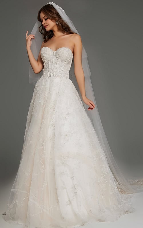 Model wearing JB42766 elegant white gown with floral lace detailing and strapless neckline.
