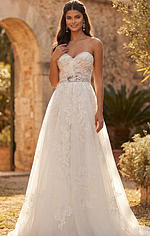 Feminine strapless bridal dress with textured lace bodice and flowing silhouette