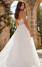 Romantic strapless wedding dress with sheer lace bodice and delicate floral embroidery