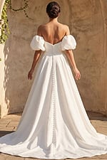 Romantic textured bridal dress with fitted bodice button back and flowing chapel train