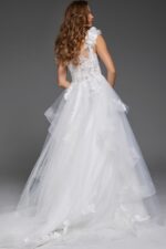 Back view of model in Jovani JB43314 ivory ball gown with floral appliques and lace detail.