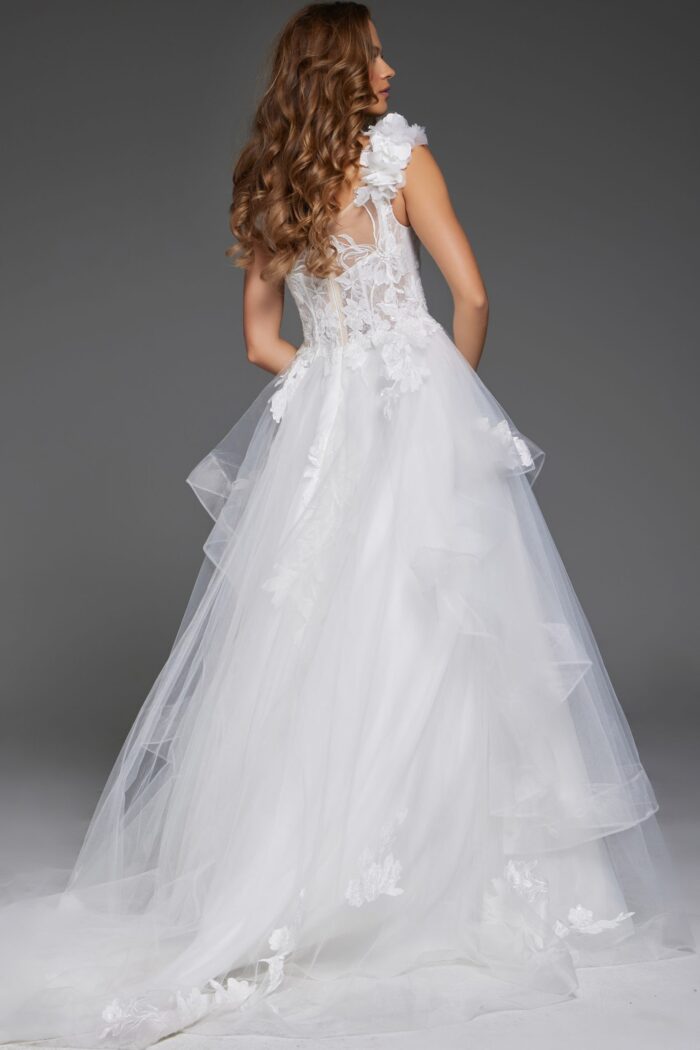Back view of model in Jovani JB43314 ivory ball gown with floral appliques and lace detail.