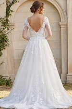 sheer lace sleeve wedding dress with low back and flowing embroidered skirt