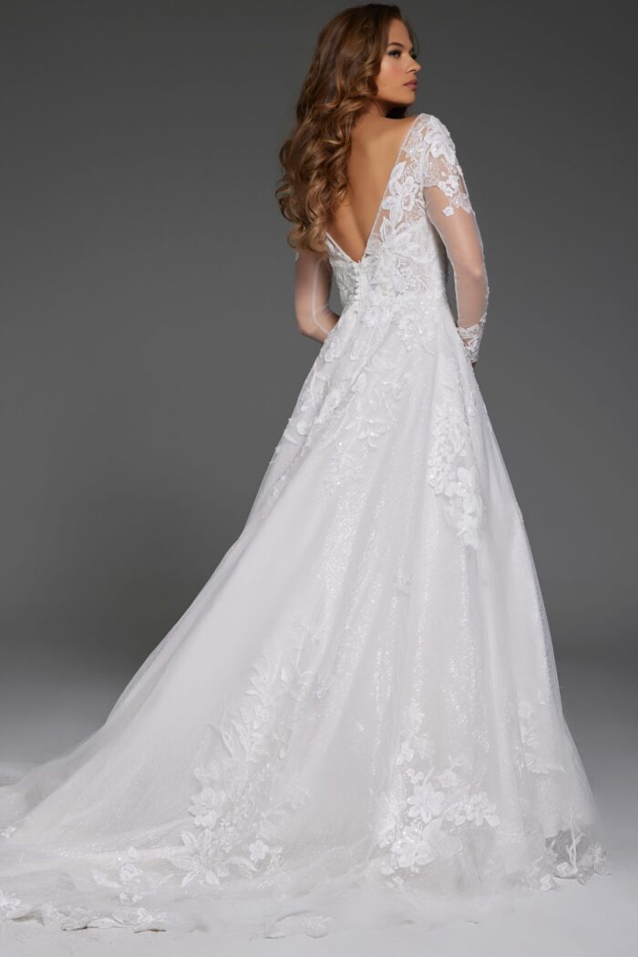 Back view of model in Jovani JB43317 ivory gown with floral lace and low V-back.