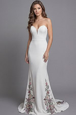 Romantic ivory mermaid gown with embroidered floral detailing along the skirt