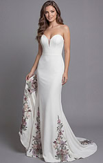 Sophisticated fitted gown with soft floral embroidery and flowing train