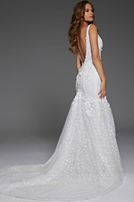 Model showcasing the back of Jovani JB43961 ivory dress with deep V-back.