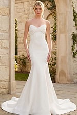 Elegant strapless mermaid wedding dress with soft sweetheart bodice and flowing train.