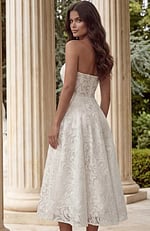 Back view of strapless lace midi dress with open neckline and elegant structure