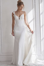 Minimalist bridal dress with a structured fitted bodice, deep illusion neckline, and a sculpted mermaid skirt.