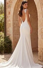 Sleek bridal gown with deep V neckline and graceful shoulder floral accent