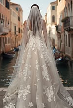Back view of lace A line wedding gown with long veil and soft train