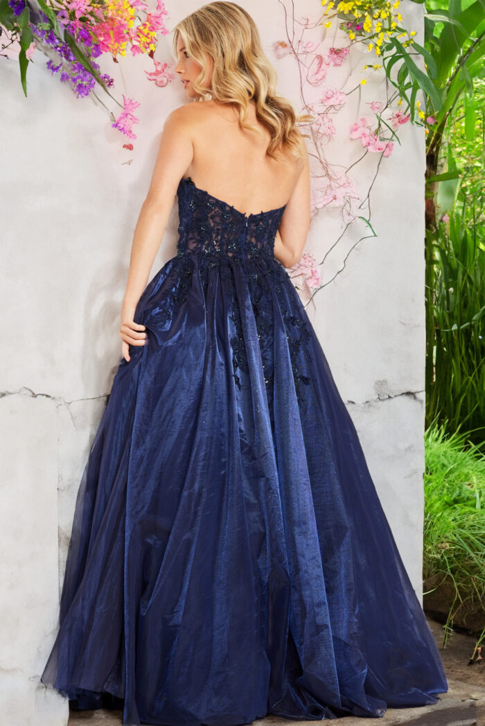 Back view of Jovani 00915 navy gown with a full skirt and intricate lace details.